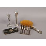 A group lot of silver items to include four piece toast rack, candlesticks, silver mounted leather