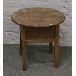 A 1940s oak work table with scalloped top.