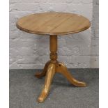 A pine tripod occasional table.