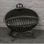 A Georgian style ovoid fire basket on cabriole feet.