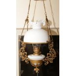 A Victorian gilt metal hanging oil lamp with milchglas burner and shade.