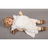 An Armand Marseille 996 Germany bisque head doll with jointed composite body.