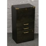 A painted brass bound filing cabinet raised over drawer and cupboard base.