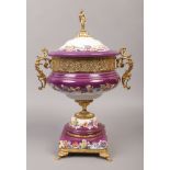 A decorative porcelain centrepiece purple ground with gilt and floral decoration and figural