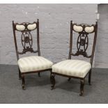 A pair of mahogany salon chairs raised on castered cabriole supports.