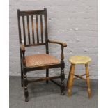 A carved slat back arm chair along with a turned leg kitchen stool.