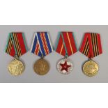 Four Russian medals including commemorative examples.