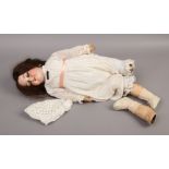 An Armand Marseille 390 German bisque head doll with composite body.