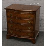 A bur walnut serpentine chest of drawers.