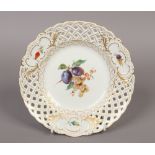 A 20th century Meissen cabinet plate with pierced lattice border and painted with fruit and flowers,