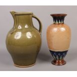 An olive green large glazed stoneware jug, along with a Royal Doulton vase, 36cm tall.Condition