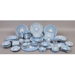 A quantity of blue Wedgwood Jasperware to include trinket boxes, vases, cabinet plates etc,