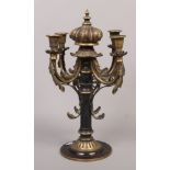 A decorative bronze four branch candelabra with gilt decoration and crown finial.