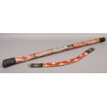 Australian interest; a decorative painted boomerang and a didgeridoo.