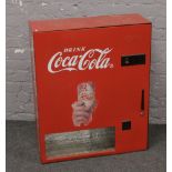 An advertising Coca Cola ice vending machine.