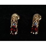 A pair of 9ct gold garnet and blue topaz ear studs.