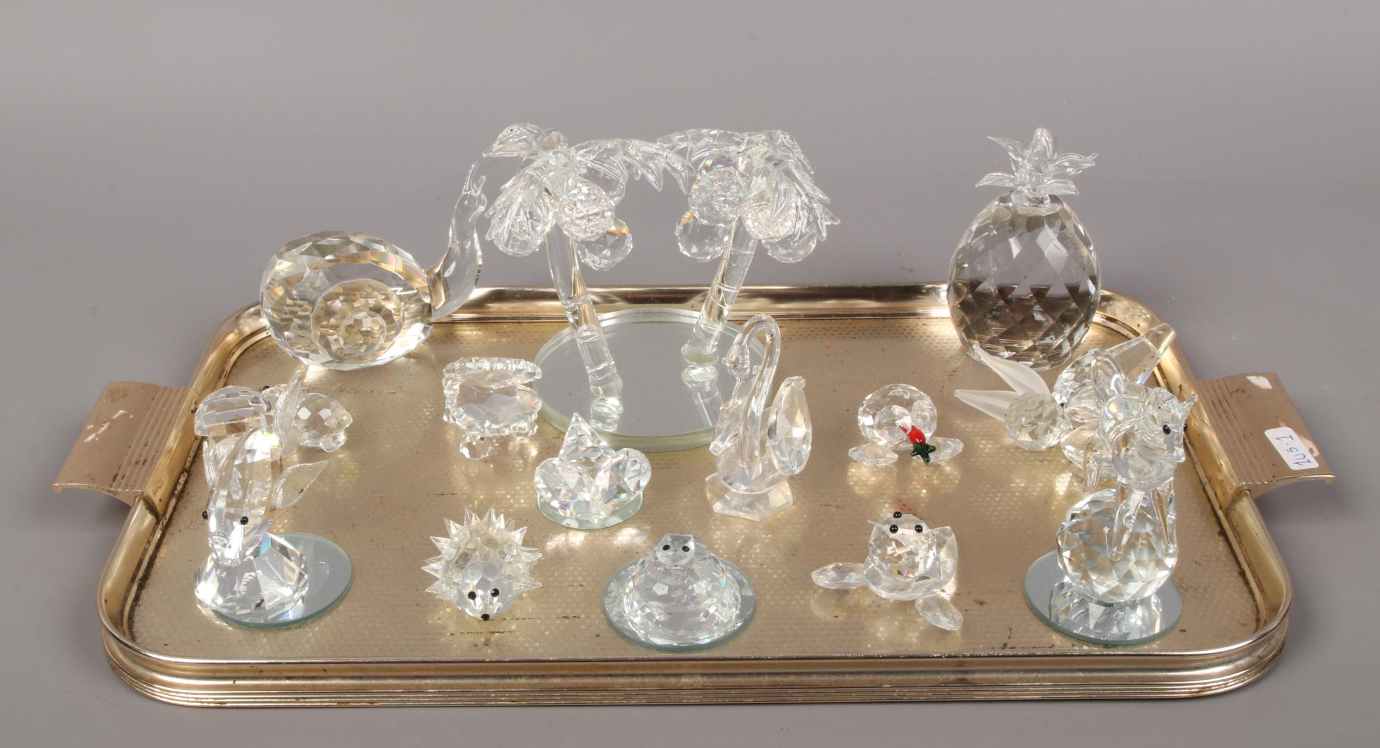 A tray of Swarovski crystal to include large palm trees, animals, pineapple etc.