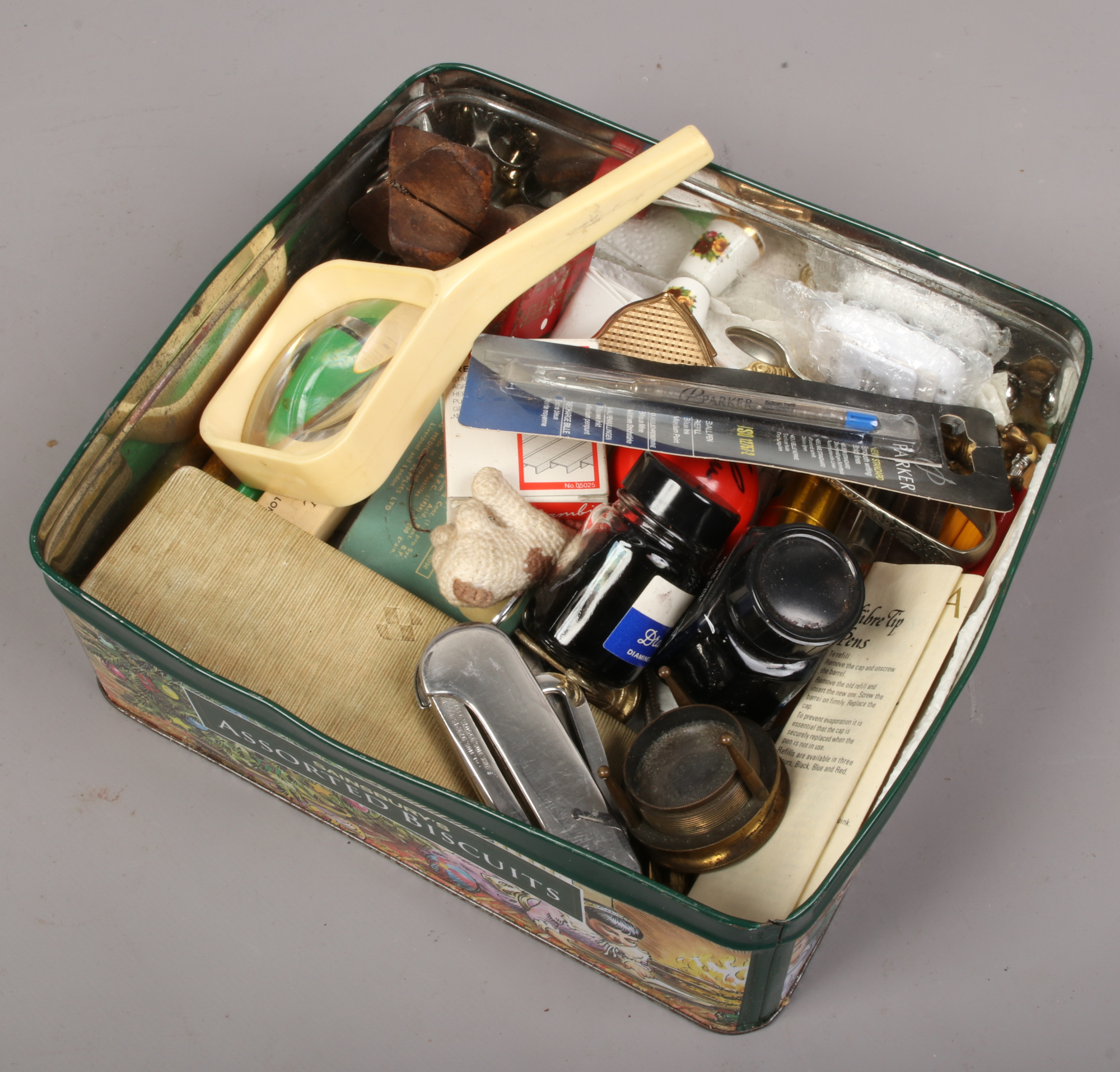 A tin of collectables to include signed snooker ball , pens, magnifying glass, black ink etc.