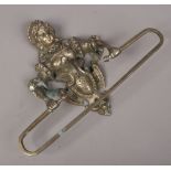 An ornate figural cast iron wall mounted towel rail.