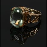 A 9ct gold dress ring set with a large ovoid pale green gem stone, size N 1/2.