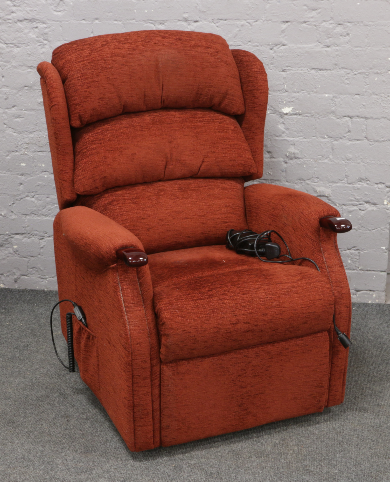 An electric upholstered reclining armchair.