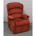 An electric upholstered reclining armchair.