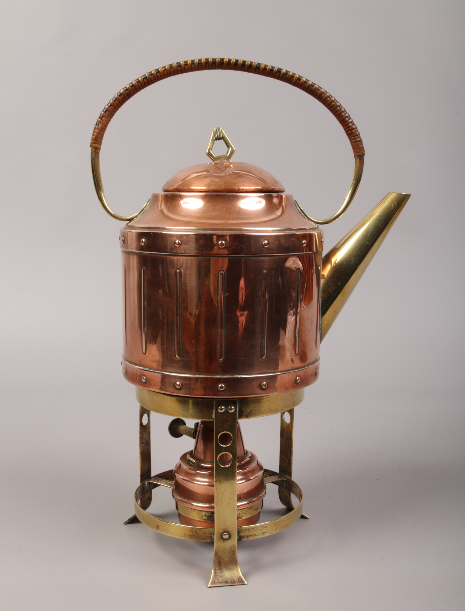 A copper and brass spirit kettle.