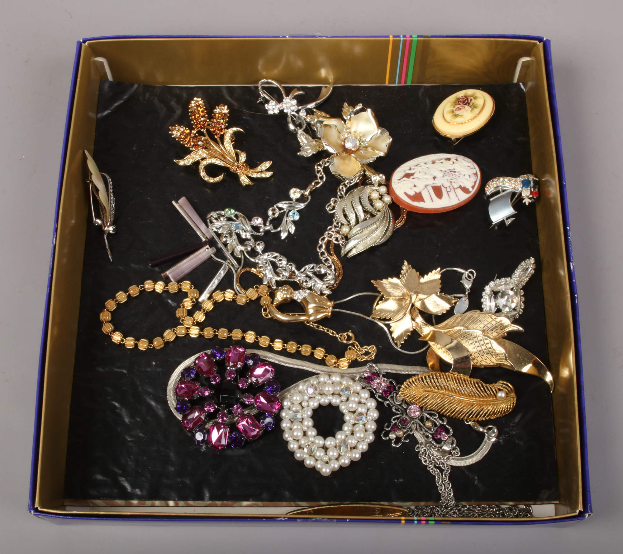 A tray of costume jewellery including gilt metal brooches, white metal necklace etc.