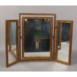 A gilt framed triple dressing table mirror.