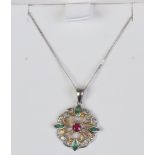 A 9ct white gold pendant and chain set with ruby, emerald and diamond.