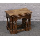 A nest of three carved and turned occasional tables.