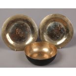 A Tibetan bronze sounding bowl and two plates.