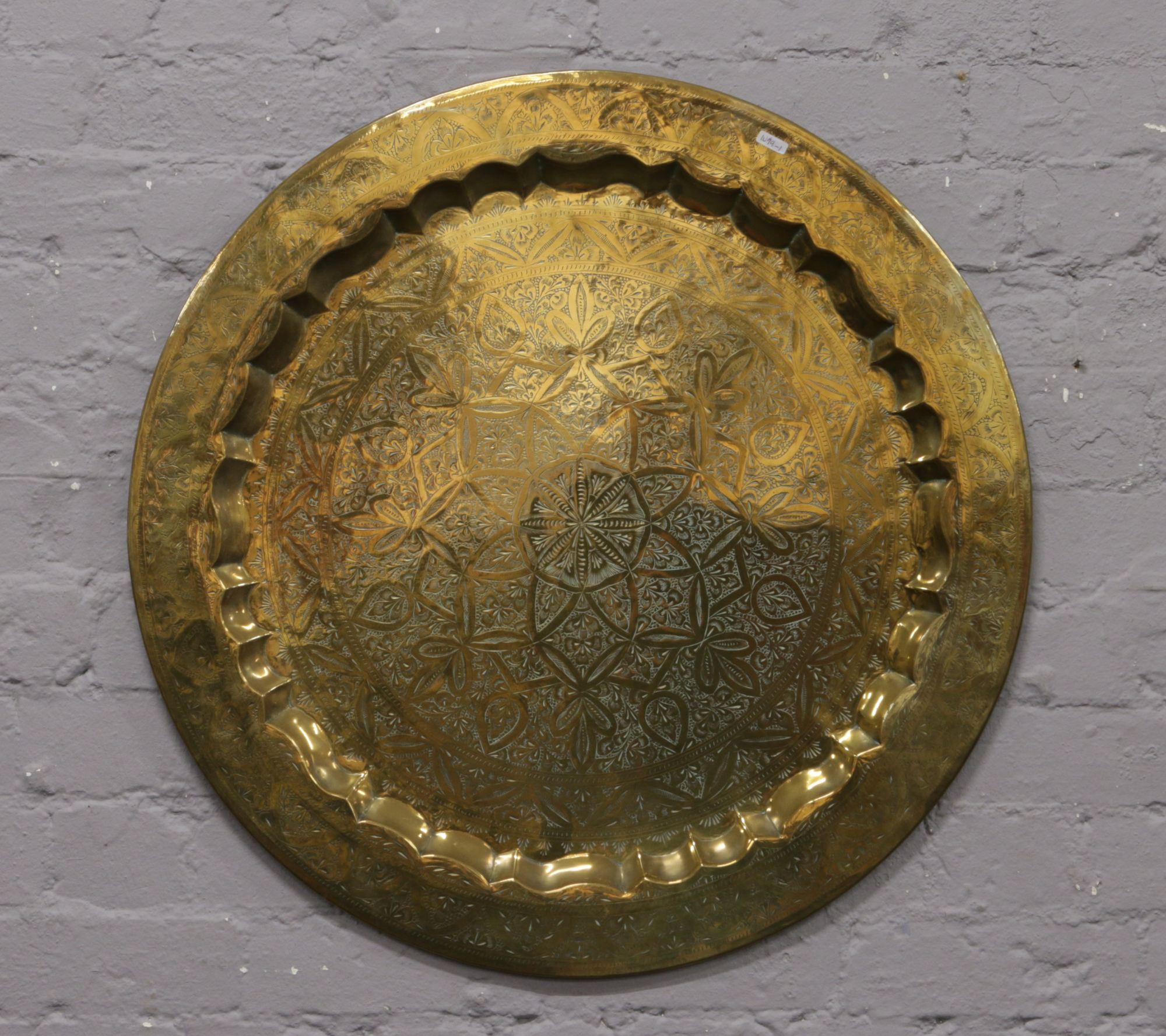 A large decorative Indian brass wall plaque.
