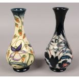 Two Moorcroft baluster vases, one decorated by R. J. Bishop along with a similar ink ground