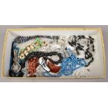 A box of costume jewellery including beads, brooches, aurora borealis examples etc.