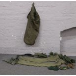 A military bag and contents including trousers, utility belt and scrim net etc.