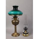 A brass based oil lamp with reeded column, along with a smaller oil lamp.