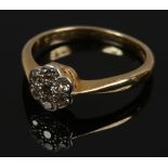 An 18ct gold and platinum diamond daisy cluster ring, size L1/2.
