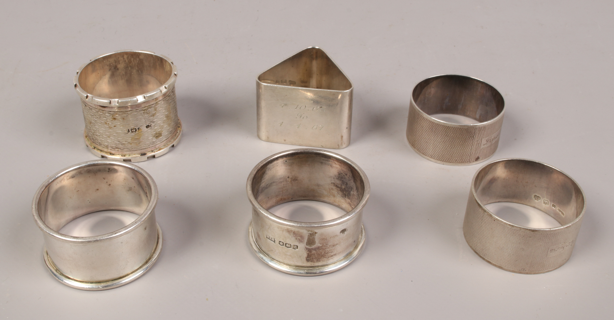 Six silver serviette rings, including two early 20th century examples by Walker & Hall, total weight