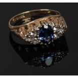 A 9ct gold dress ring set with blue and white stones in a boat shaped setting, size N.