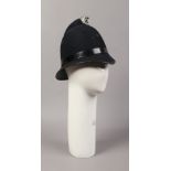 A shop mannequin head and a fancy dress police helmet.