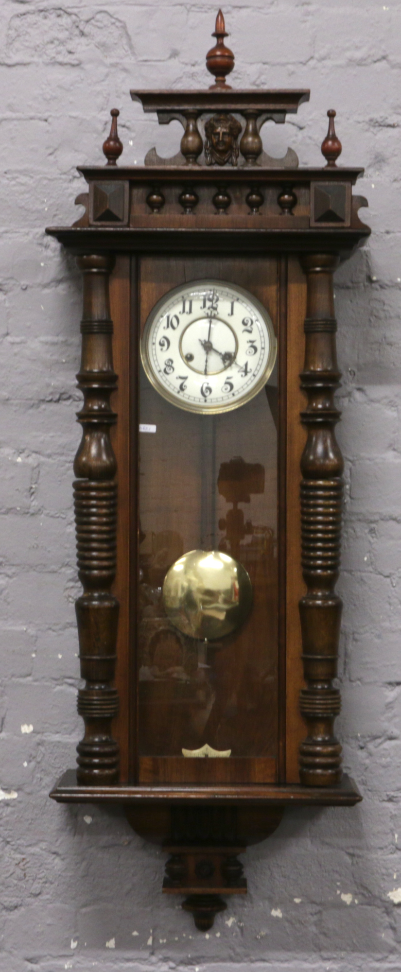 A mahogany cased Vienna Springer wall clock with white enamel dial chiming on a coiled gong.