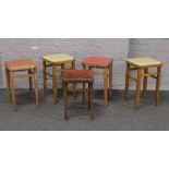 Five wooden stools four with vinyl seats.