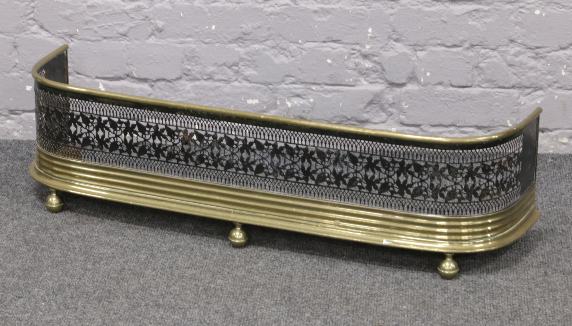 A Victorian pierced brass and steel nursery fire fender.