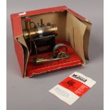 A boxed Mamod model of a steam engine.