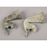 Two archaic bronze stirrup cups each surmounted by a wild cat.