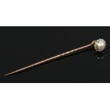 A cased Victorian yellow metal floriform pearl and diamond adaptable stick pin / shirt collar stud.