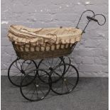 A Victorian style basketware dolls pram.