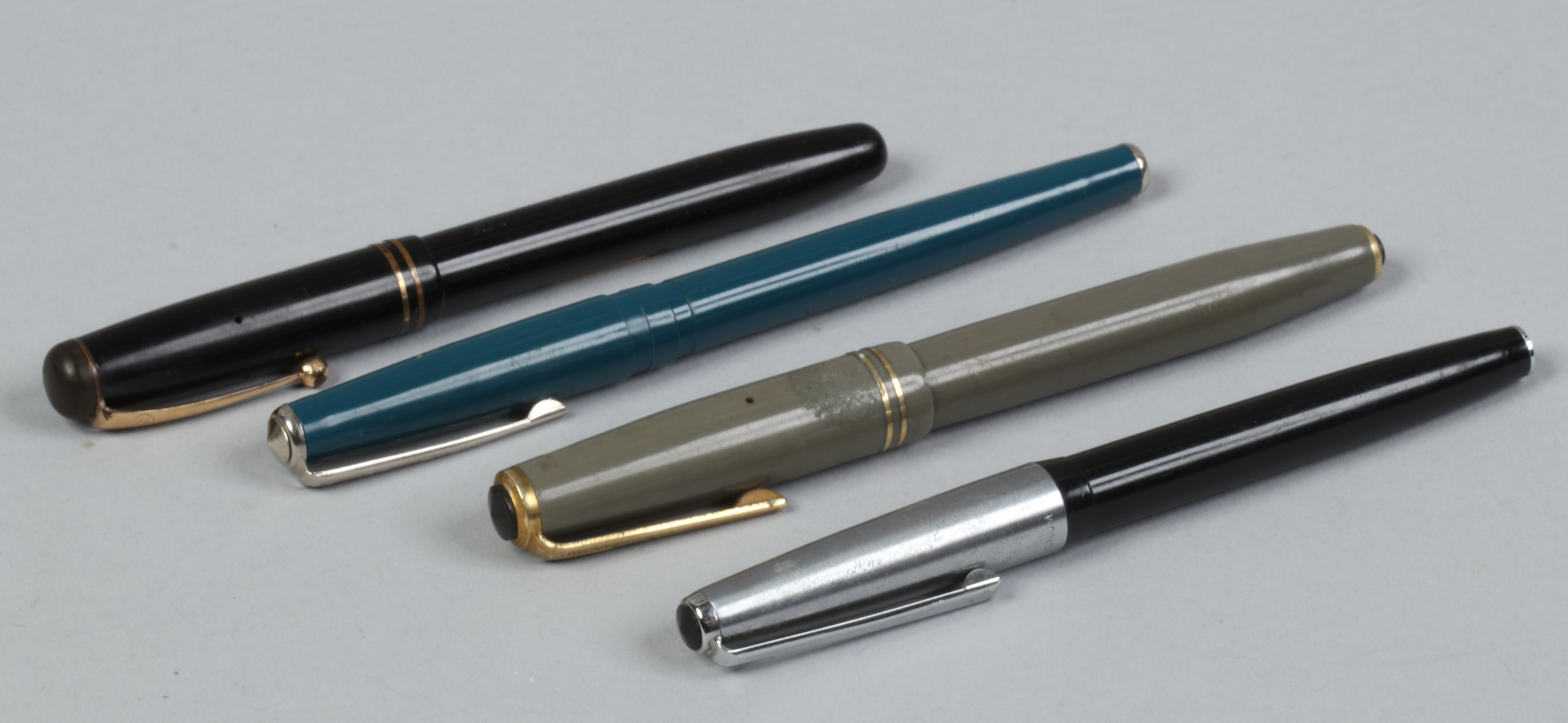 Four fountain pens to include 14ct gold nib, Alfred Gilbert & Son Ltd example.