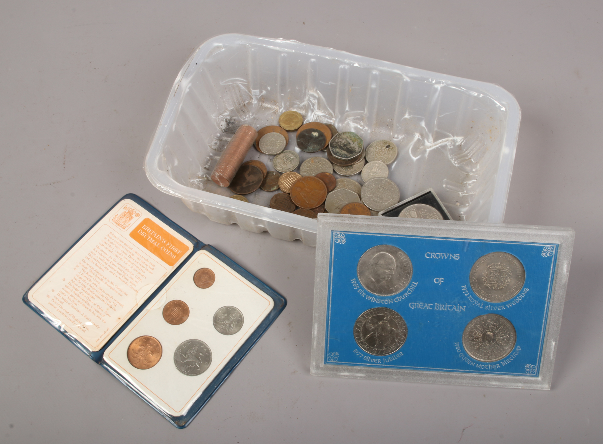 A quantity of mostly British pre decimal coins, including three pence, half crowns, one shillings